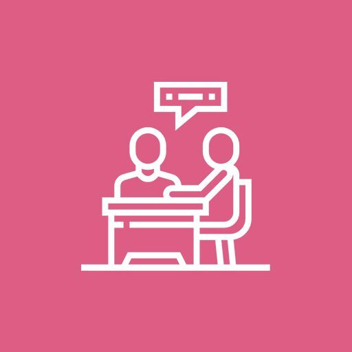 Two people engaged in a conversation at a table, symbolizing communication.